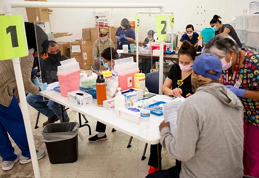 Healthcare Network employees vaccinate farmworkers at the Florida Department of Health in Collier County site on Lake Trafford