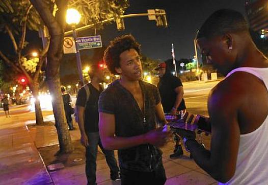 Thomas Davis spends a night in September asking people in West Hollywood to participate in a UCLA study about mobile apps and their ability to help improve health and combat disease. (Michael Robinson Chávez)