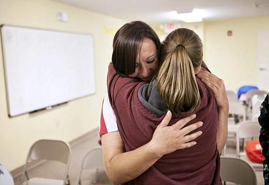 Cumberland Hope Community residents Tameka Napier, right, and Lauren Radzimirski console each other after Radzimirski was questioned by peers to gain a better understanding of her strengths and areas to improve. 