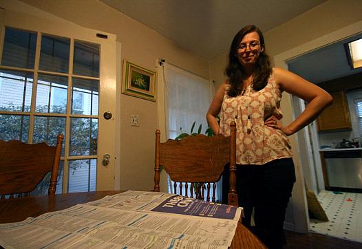 Mary O’Connor, 24, of Sacramento, who voted “yes” on California’s proposition 61, looks at a voter guide she used to help her fi
