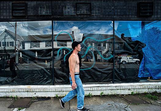 Travis Litts walks past an abandoned business along East Ridge Street in Lansford. He is one of Pennsylvania's many rural reside