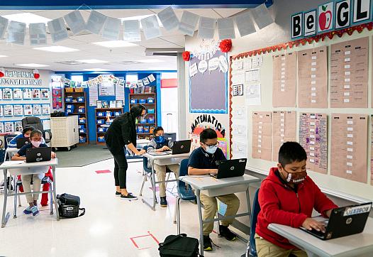 Fifth-grade teacher Uyslamis Echeverria-Ramos helps a student at RCMA Immokalee Community School in Immokalee.