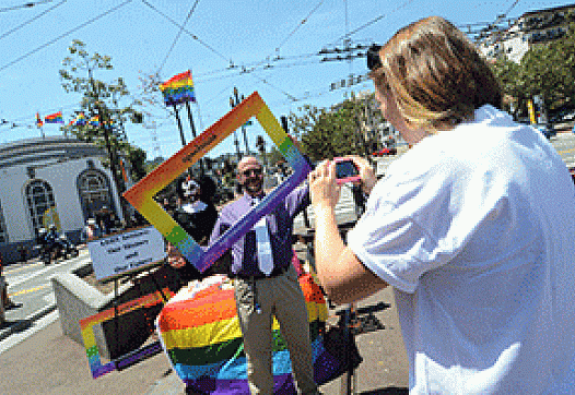 Natalie Summers from Openhouse, right, took a photo of Sister Rose Mary Chicken and E.J. Hebert in Jane Warner Plaza.