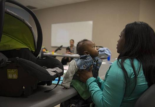 Robin Evans holds her 5-month-old son, Mekhi, during a safe-sleeping workshop in Meadowview. 