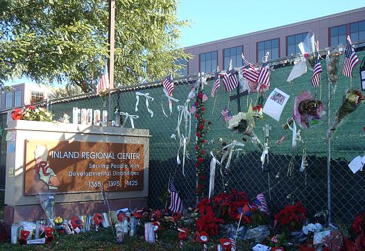 Tributes and holiday decorations adorned the wall surrounding the Inland Regional Center.