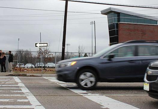 Drivers hurry past Burlington City High School on northbound Route 130.