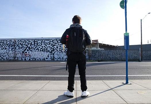 Frankie Serrano waits for a bus. It's one leg of a long journey he does every morning to stay in his school.