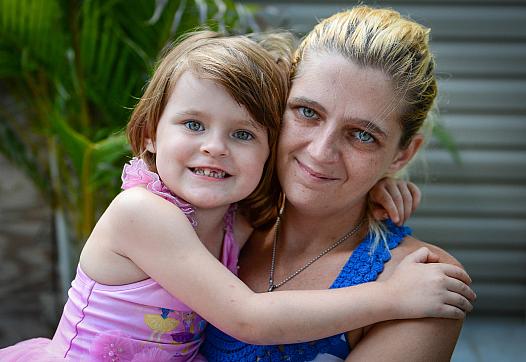 Keriana Carll, 4, and Megan Johnson pose in their yard in Bradenton. Johnson searched for months to find a dentist who was willi