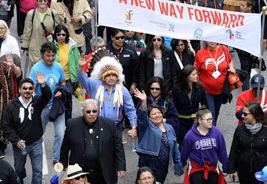 JUSTIN TANG/THE CANADIAN PRESS Truth and Reconciliation commissioner Murray Sinclair, in a black suit, marches along with Assembly of First Nations Chief Perry Bellegarde (in headdress) in an Ottawa march on Sunday that was part of the closing events of the commission's work. Between 7,000 and 10,000 participants marched. 