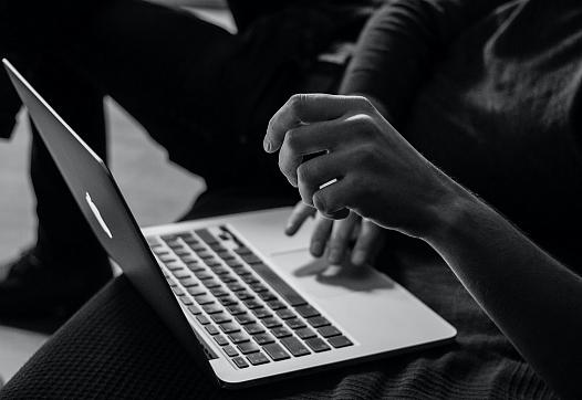 Person using laptop shown.