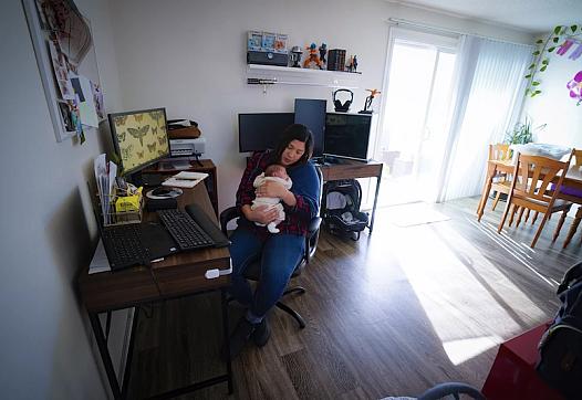 Zaira Reynoso juggles caring for her 2-week-old baby, Ander, and checking email at her home in Chula Vista.