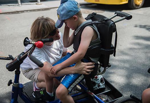 A mother comforts her son during the first annual Disability Pride Parade in 2015 in New York City.