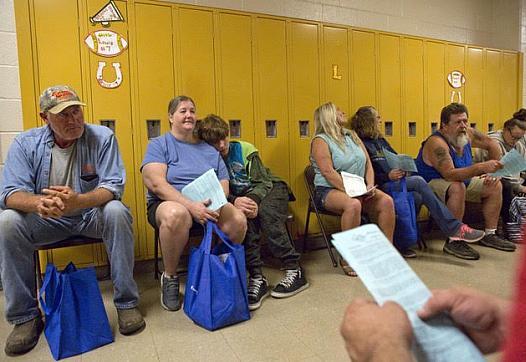 People wait for vision care at Lee County High School during a remote area medical clinic last year. 