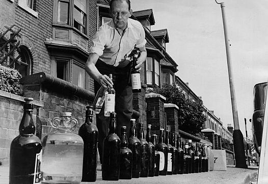 A man who objects to the addition of fluoride to drinking water fills bottles with unfluoridated water from his friends' home.