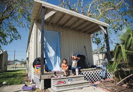 Laila Garcia, 4, left, and her sister, Zoey Garcia, 5, sit on the front porch of their apartment in Bloomington in Sept. 2017.