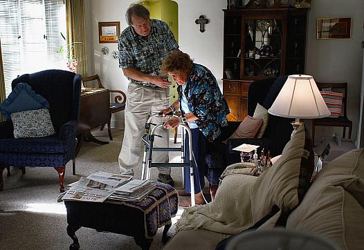 Nurse Stephen Van Dyke helps Mary Donahue, 100, with her exercises in her Denver home. A local nonprofit provides free home nurs