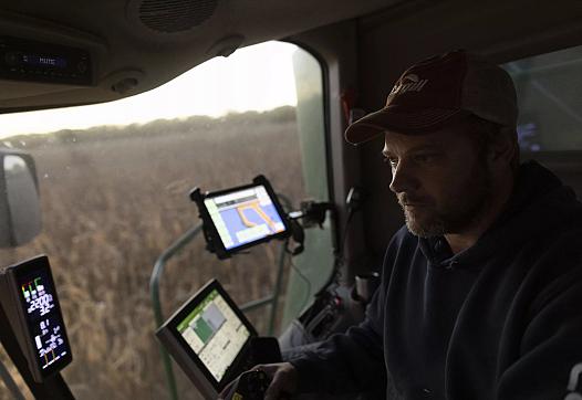 Farmer Jason Othmer operates a combine as he harvests corn near Vesta, an unincorporated community in Johnson County, on Tuesday