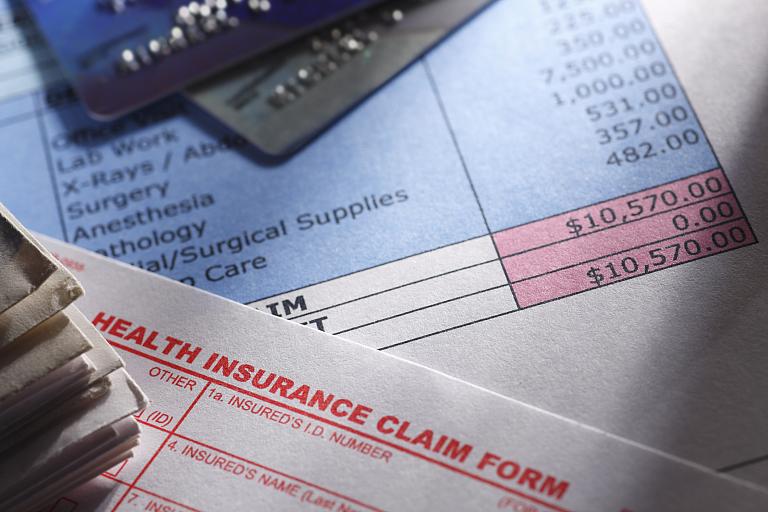 Medical bills on a desk.