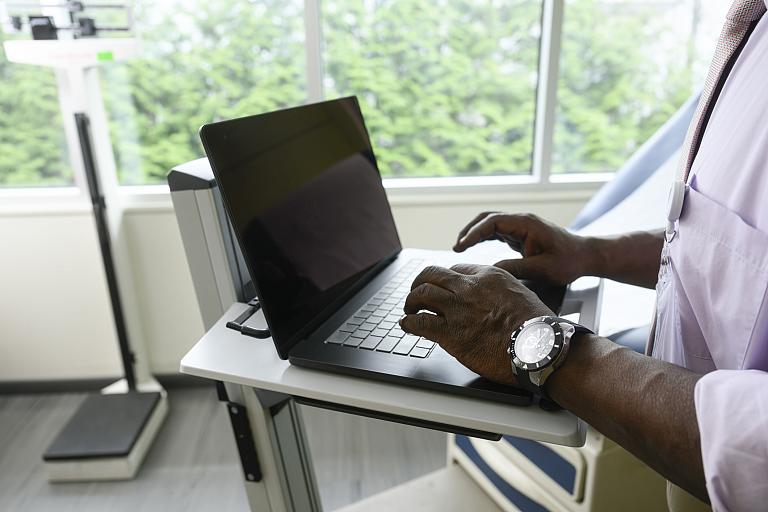 Health provider uses a computer.