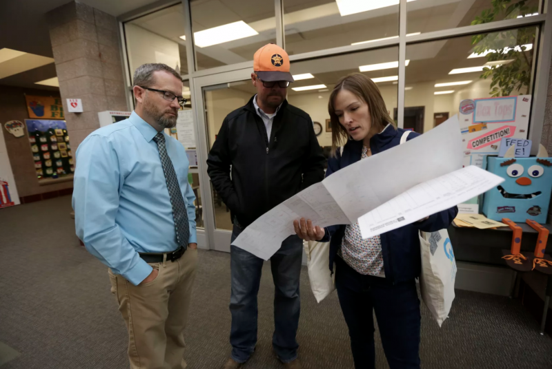 Ephraim Elementary principal Gannon Jones, Ephraim Elementary custodian Tyler Alder and Deseret News special projects reporter Sara Israelsen-Hartley look over a map of the school while preparing to put radon test kits in classrooms in Ephraim Elementary School in Ephraim on Tuesday, Oct. 8, 2019. Kristin Murphy, Deseret News