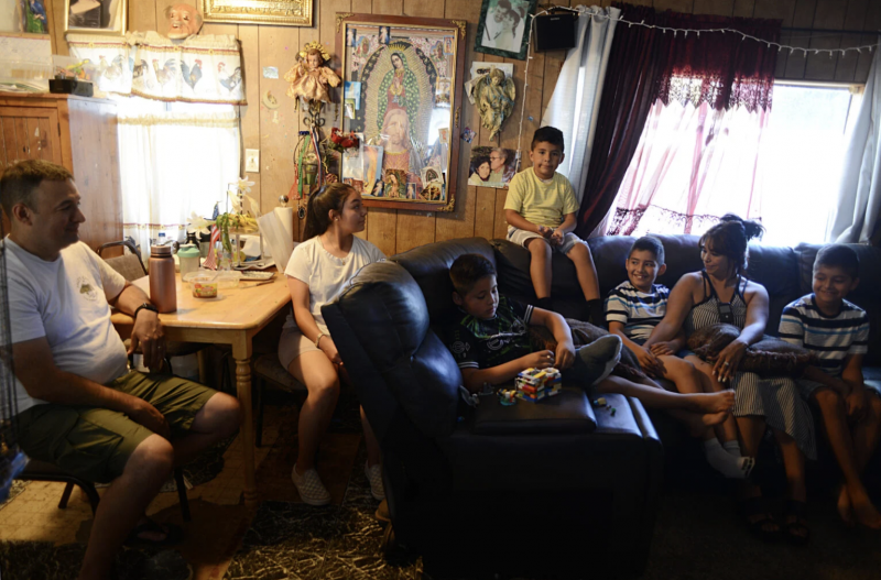 La familia Gutiérrez en su casa el 9 de julio 2021. Jerry y Diego se sientan en la cocina de la familia, que también ha sido un salón de clases para los niños durante la pandemia. El arte de los niños cubre la nevera de la familia, incluyendo una nota cariñosa del hijo de Alma, Diego Dana Ullman / The Mendocino Voice