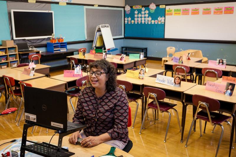 Olga Contreras began teaching her students remotely from her classroom at Saucedo Scholastic Academy in September. She doesn’t have a teacher’s desk because she’s normally walking around all day. This fall, she sat at a children’s table. Michelle Kanaar / WBEZ