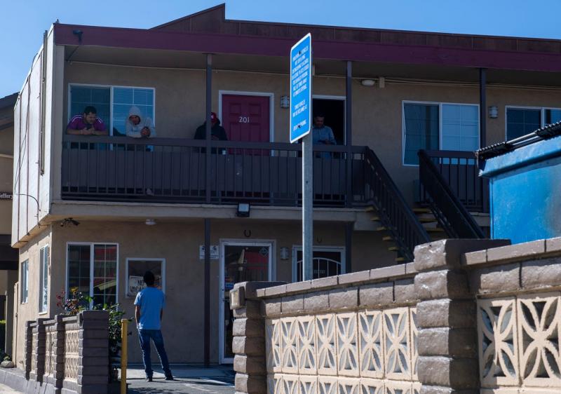 A few H2A workers hanging out on the second floor of the Budget Inn Motel in Salinas talk to a person standing just right outside their room on April 2, 2020. David Rodriguez/The Salinas Californian