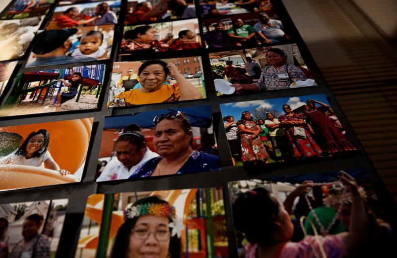 Pictures hang on a wall showcasing members of the Marshallese community now living in Dubuque, Iowa. | M. Scott Mahaskey / POLITICO