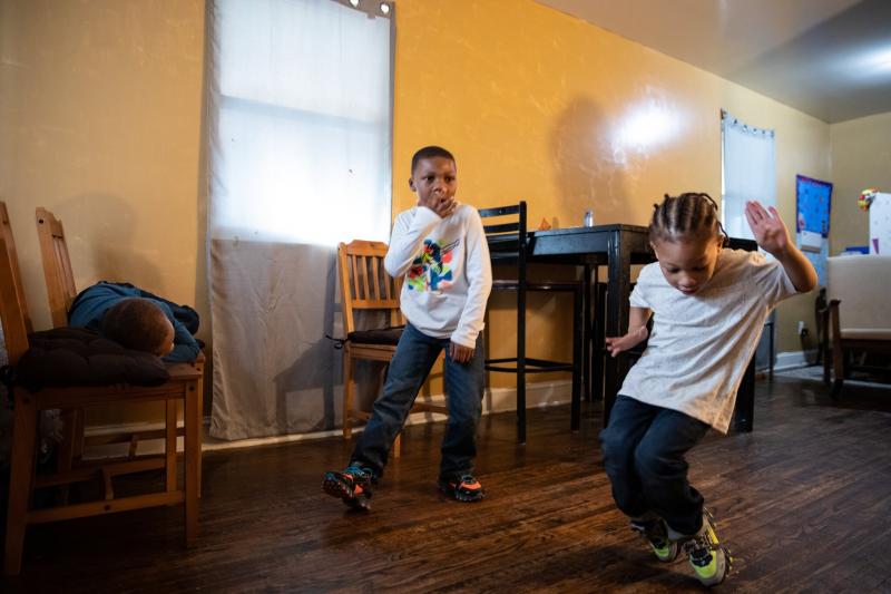 Jermiah, 6, and Markette, 4, danced in their home. Their mother, Ms. Porter, schedules story time and dance time, and helps her children with reading, math and science.Credit...Cheriss May for The New York Times  Image