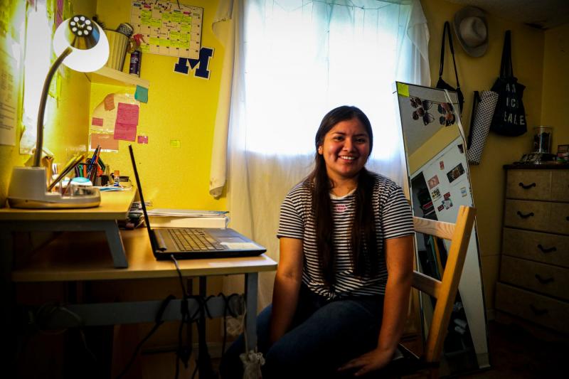 Luz Vazquez Hernandez in her room in Mulberry, Florida. This is where she spent most of her time working on homework during the pandemic. She was taking three AP classes during virtual school, which she balanced with working during the school day in the fields. This spring she graduated with a 3.9 GPA. ANDREA MELENDEZ/THE USA TODAY NETWORK-FLORIDA