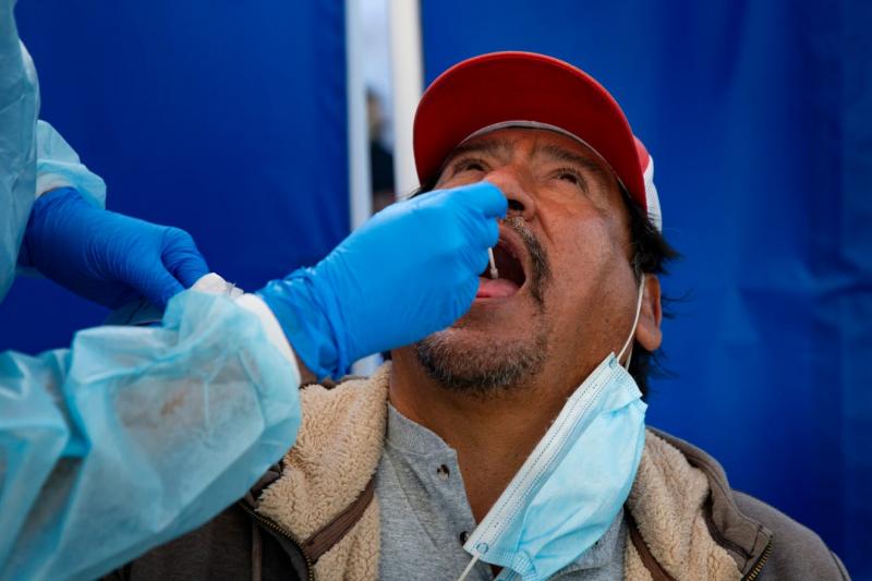 Martin Victoria of Immokalee provides samples for a COVID-19 test Dec. 29 at a state-run testing site at Farm Workers Village in Immokalee. Jon Austria/Naples Daily News