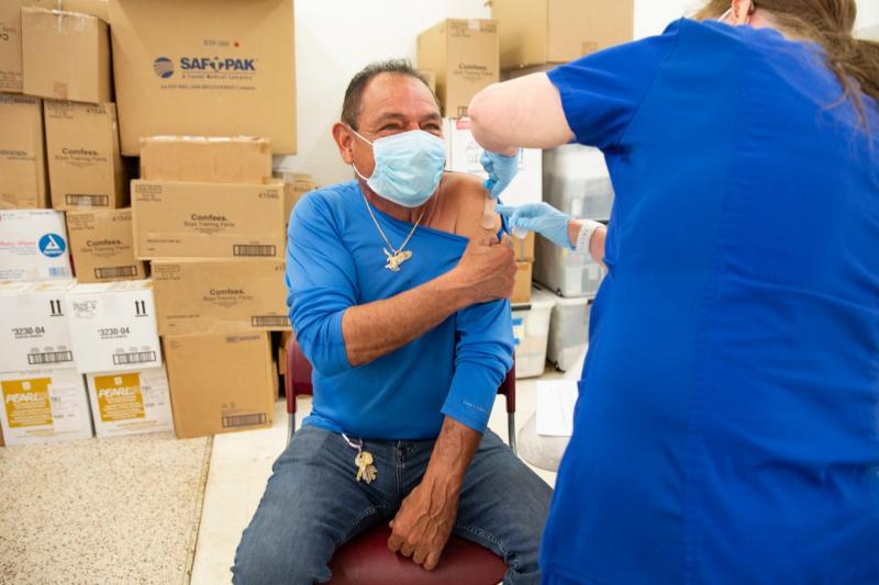 Armando Izaguirre, of Immokalee, has a bandage applied to his arm after receiving his COVID-19 vaccine during a Healthcare Network vaccination clinic, Tuesday, Feb 9, 2021, in Immokalee. Jon Austria/Naples Daily News USA TODAY NETWORK - FLORIDA