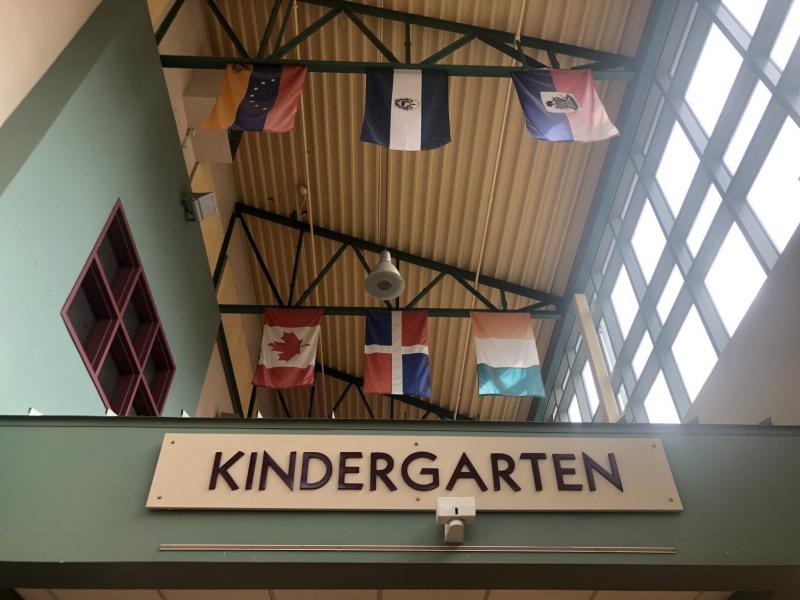 The atrium at Mary Harris Mother Jones Elementary school in Prince George’s County, Maryland, is lined with flags from different countries, including those in Central America. The recently retired principal Dr. Karen Woodson hopes that when children recognize their flag, they know they are welcome. Credit: Kavitha Cardoza for The Hechinger Report