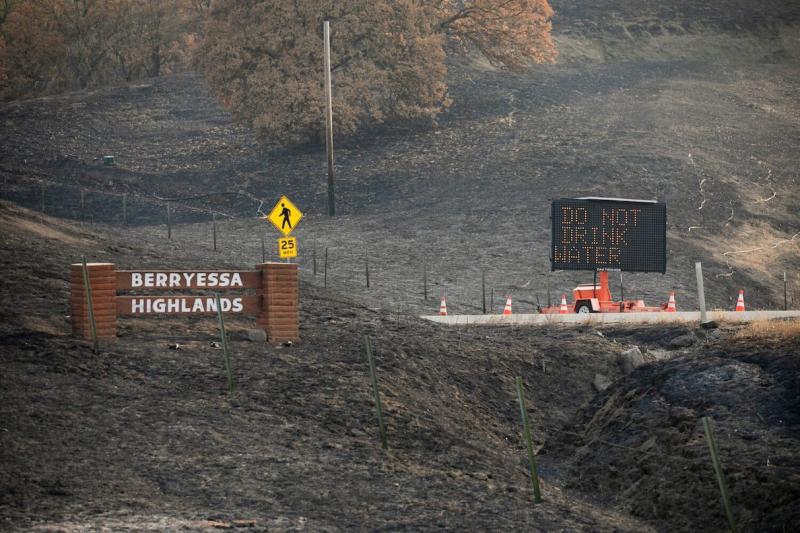 A sign warning residents not to drink the water is posted along Steele Canyon Road at the entrance to Berryessa Highlands on Sept. 21, 2020. (File photo courtesy of Anne Wernikoff/CalMatters)
