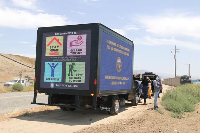 A local labor rights car caravan, stopped on July 28 near a field on Foxen Canyon Road, is led by an LED billboard truck, with screens displaying contact information for state labor agencies and information about workers' rights.   Laura Place, Staff