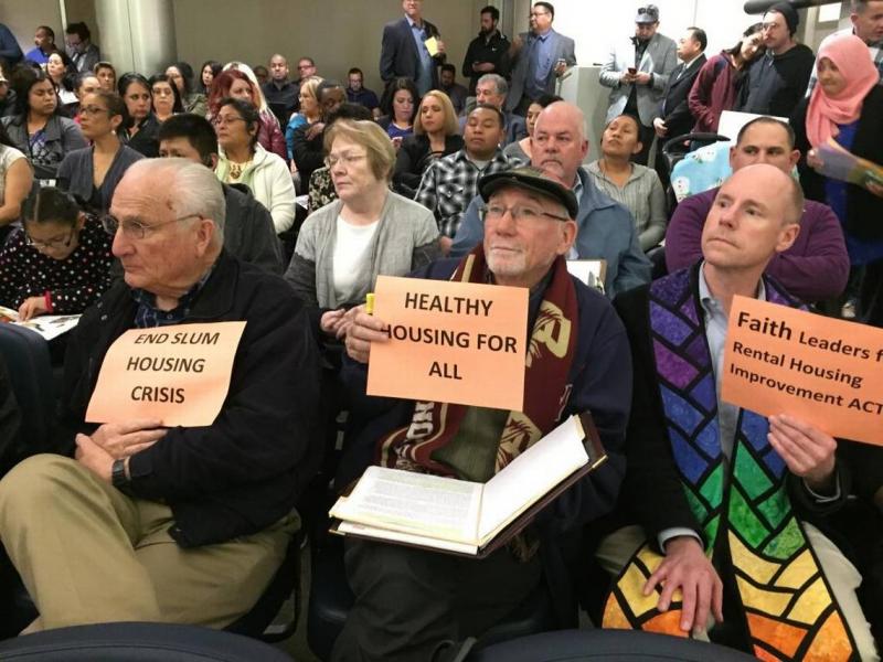 From left, St. Paul Catholic Newman Center deacon William Lucido, Roman Catholic Diocese of Fresno director of social ministry Jim Grant and Unitarian Universalist Church of Fresno Rev. Tim Kutzmark hold signs during a City Council meeting at which Fresno Mayor Lee Brand presented his rental housing inspection plan on Thursday, Feb. 2, 2017, at City Hall in Fresno. SILVIA FLORES SFLORES@FRESNNOBEE.COM