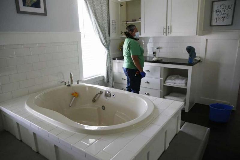 Maria Peña cleans one of three birth houses at the Holy Family Birth Center. It’s one of the only free-standing birth centers in Texas that operates as a nonprofit to serve mothers and babies who might otherwise face barriers to health care. (Jerry Lara /Staff Photographer | Express-News)