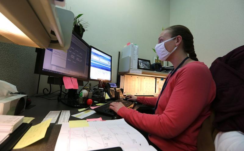 Child abuse hotline operator Amanda Whitlock works on abuse reports at her workstation on Jan. 27 at the Arkansas State Police headquarters in Little Rock.
