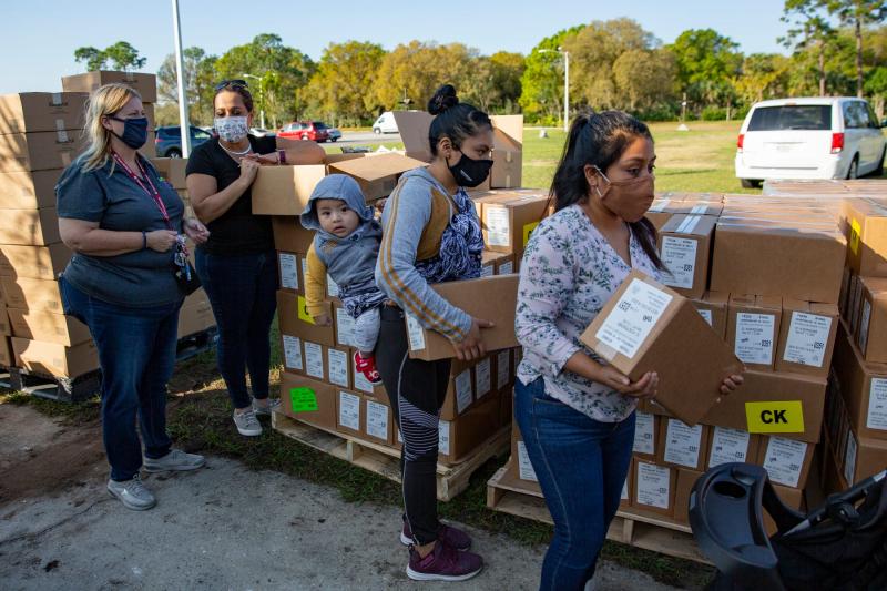 Community members collect boxes containing food during a homeless count in January hosted by the Collier County Hunger and Homeless Coalition at Guadalupe Social Services in Immokalee. JON AUSTRIA/NAPLES DAILY NEWS USA TODAY NETWORK - FLORID