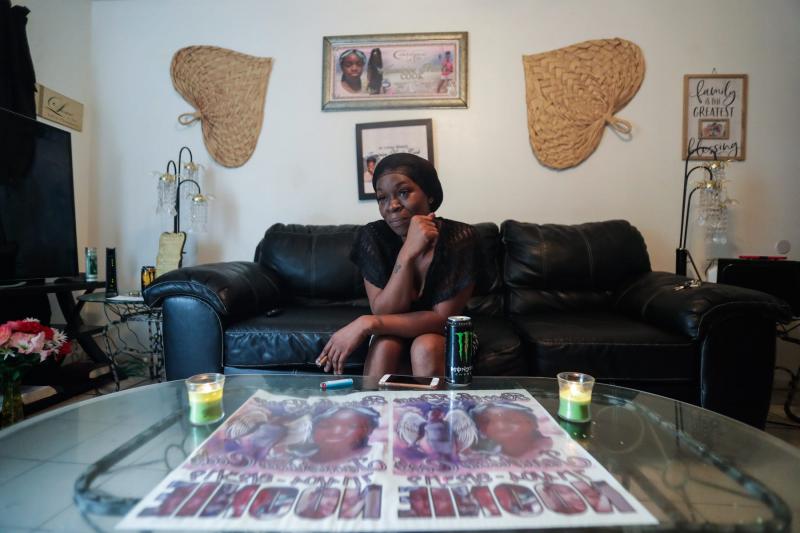 Koquisha Cook, 36, sits in her living room as she shares fond memories of her daughter Jamirica "Noonie" Cook, 15, who was shot and killed last year in her home in the Springfield Apartment complex. Photographs and tributes to Noonie decorate Cook's home. ALICIA DEVINE/TALLAHASSEE DEMOCRAT