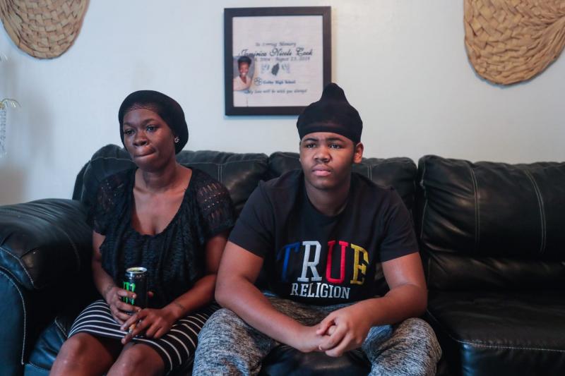 Koquisha Cook, 36, sits with her son Matthew Cook, 17, in their living room. Matthew is facing charges on the shooting and killing of his sister last year. ALICIA DEVINE/TALLAHASSEE DEMOCRAT