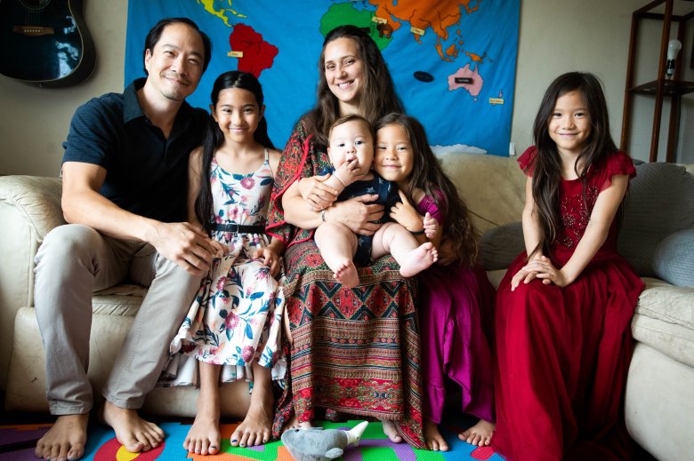 Tameka Issartel poses with her husband Yukio Hoshi and their children Kalea, 10, Tenshin, 7 months, Nalani, 5, and Luana, 7, in their El Sereno living room on Thursday, September 9, 2021 where she birthed Tenshin. Midwife Racha Tahani Lawler pulled off her N95 and performed CPR all the way to the hospital after Tenshin struggled to take his first breath. (Photo by Sarah Reingewirtz, Los Angeles Daily News/SCNG)