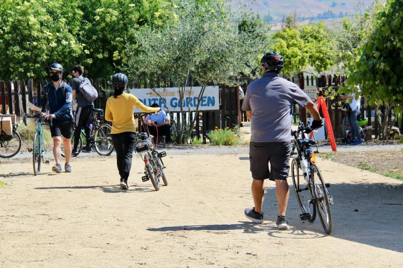 Cyclists meet at the garden facilities at the Veggielution Community Farm in San Jose before departing as individuals or small groups to make food box deliveries on May 1, 2021. Courtesy Silicon Valley Bicycle Coalition.