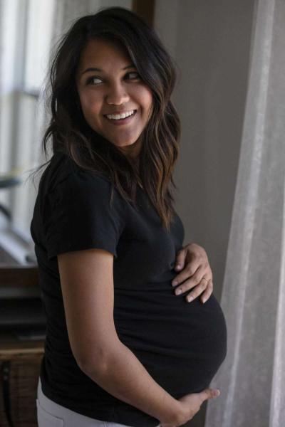 Marissa Mayberry, 28, poses at her home in Hondo, Texas on May 19, 2020. Marissa usually drives an hour each way to her midwife for prenatal care but has now been given the medical equipment to do it herself until the last few weeks of her pregnancy.  Josie Norris, The San Antonio Express-News / Staff Photographer