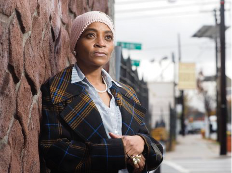 Tamika Darden-Thomas stands on Bergen Street in Newark. In April, Darden-Thomas' 85-year-old grandmother, Nora Darden-McNeil, and 66-year-old uncle, Vincent Eley, succumbed to the virus.  Patti Sapone | NJ Advance Media