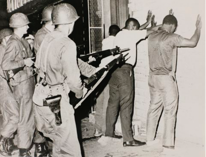 New Jersey National Guardsmen holding men at gunpoint during the Newark riots in 1967. Picture collection/Newark Library