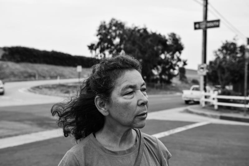 Alicia Rivera, a long-time advocate for environmental justice and organizer for Communities For A Better Environment, walks through Figueroa Place in Wilmington, California. Pablo Unzueta