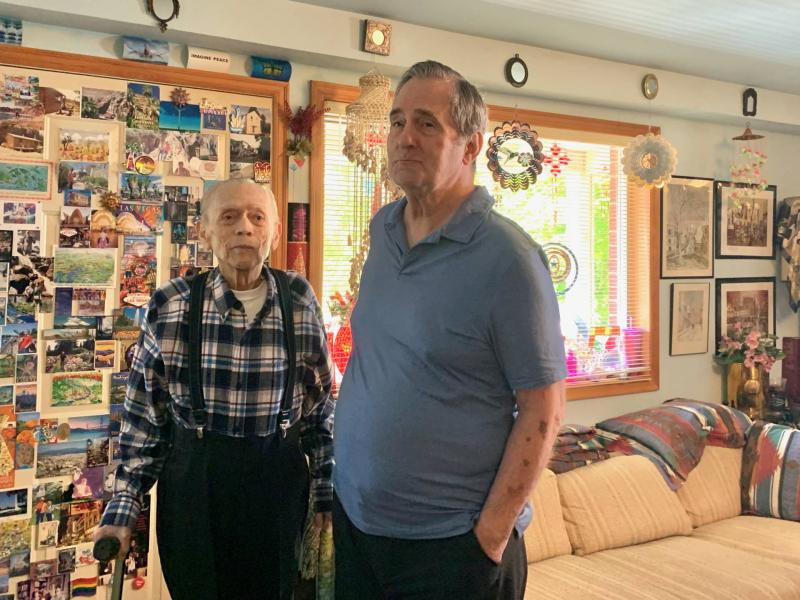 Gene Ampon and Roger Anderson had been together for 44 years when a reporter visited their Seattle home on Queen Anne hill in August 2021. Their walls are covered in photos and postcards of their global adventures. (Lee Romney/KQED)