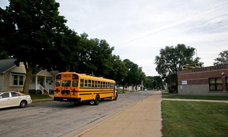 A school bus passes by Starms Discovery Learning Center at 2035 N. 25th St. on Aug. 15, 2022. ANGELA PETERSON/MILWAUKEE JOURNAL SENTINEL