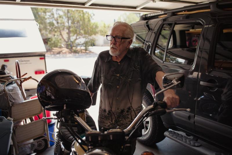 Steve Harbin stands next to his motorcycle in his garage in Albuquerque on June 29, 2022. Adria Malcolm/New Mexico In Depth